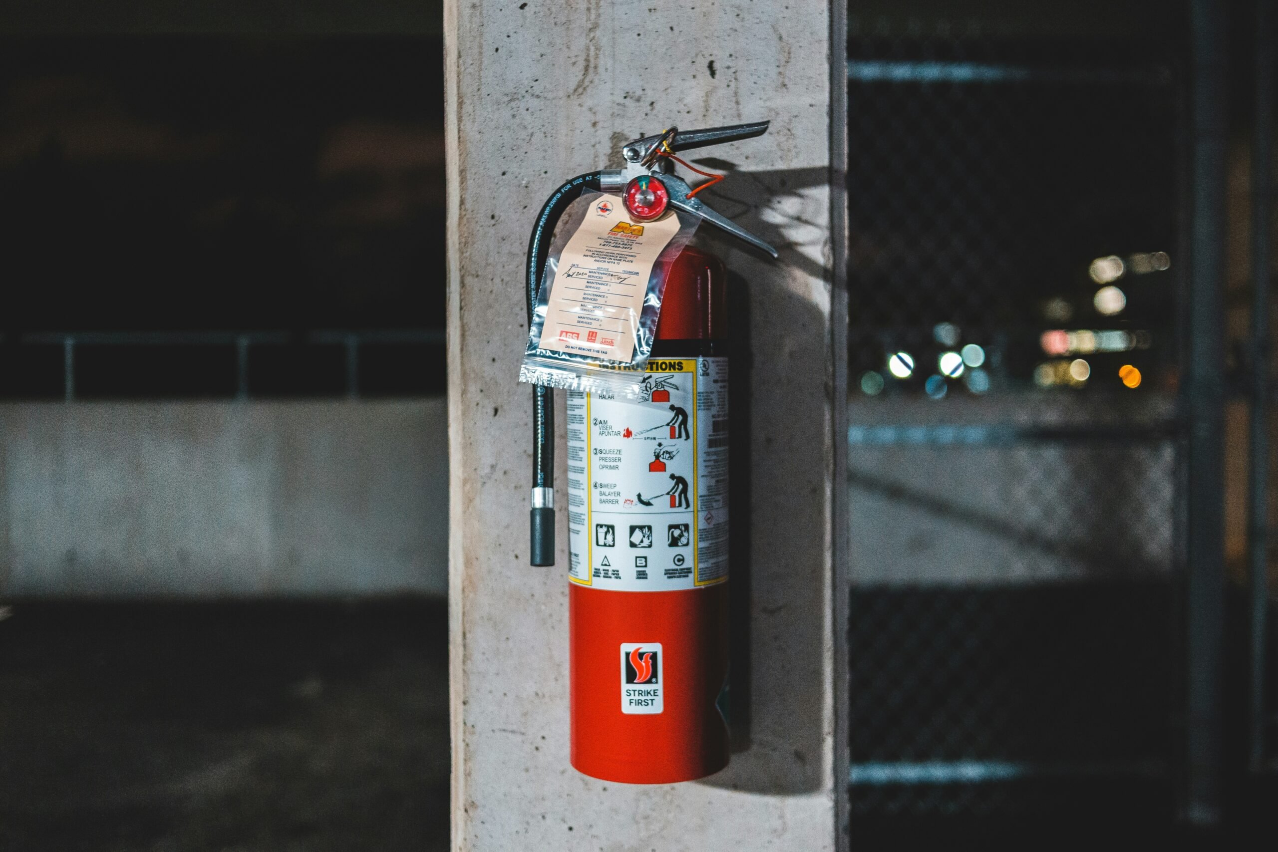 Photographer is a red fire hydrant hanging on wall with instructions of use 